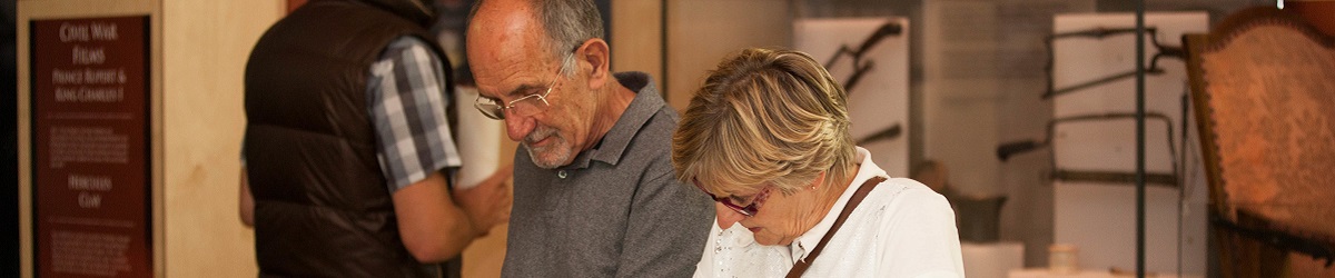An older couple gaze down at an exhibit in the main Civil War gallery